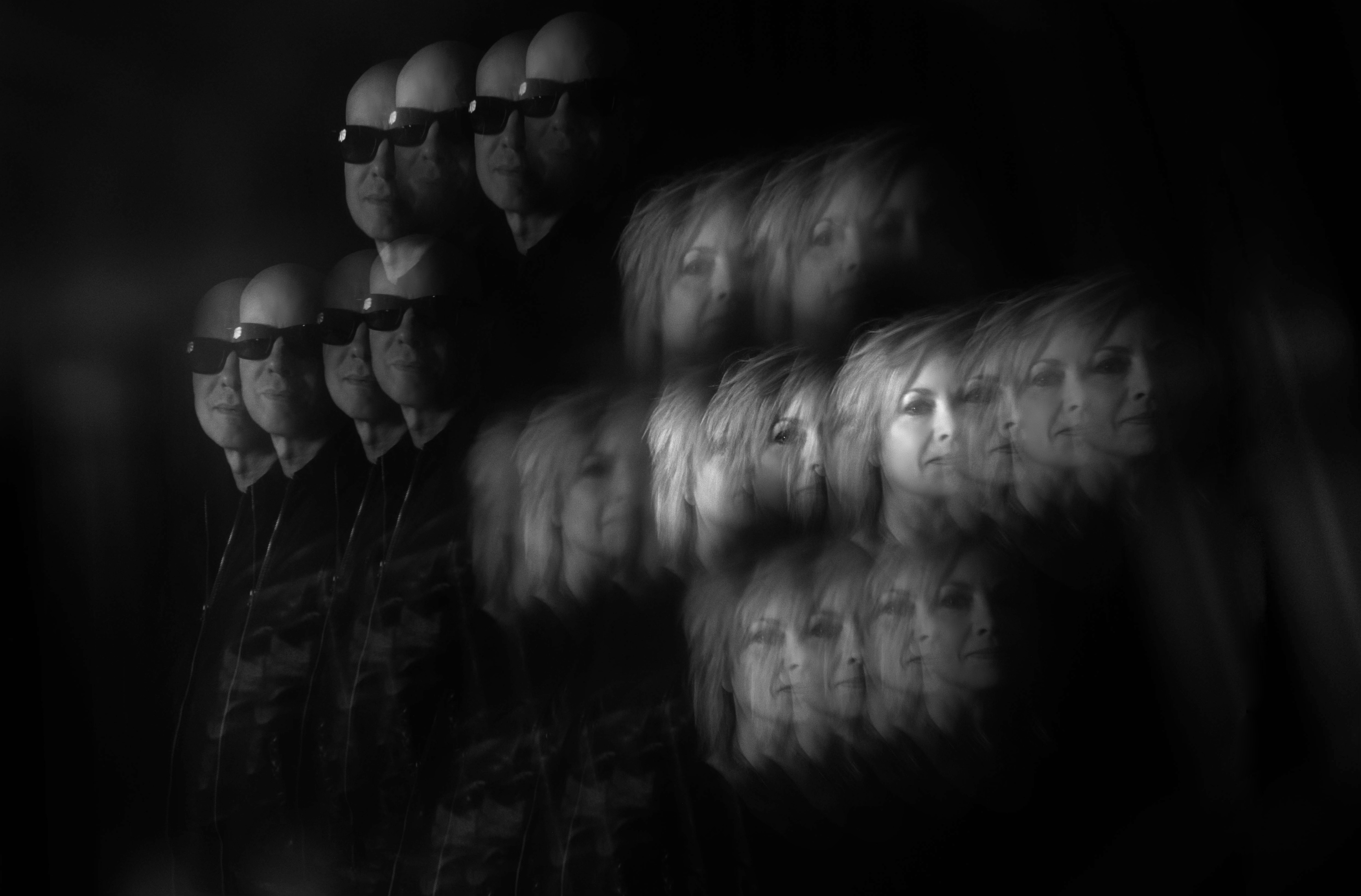 A black and white photo of the rock band Reaper On Red featuring ghostly multiple images of band members Robert Cherry and Carla Cherry. 
